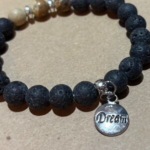NATURAL LAVA STONE BEADED BRACELET W/ANTIQUE SILVER CHARM
